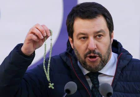 Italian Northern League leader Matteo Salvini shows a rosary as he speaks during a political rally in Milan, Italy February 24, 2018. REUTERS/Tony Gentile