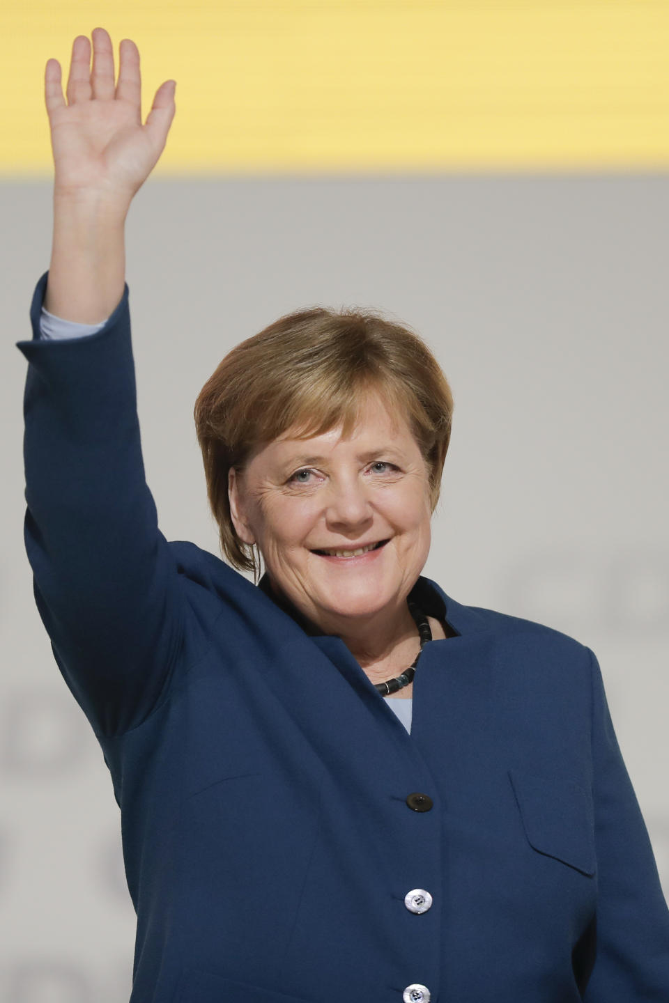 Christian Democratic Union, CDU, chairwoman and German Chancellor Angela Merkel waves as she receives the applause after her speech during a party convention of the Christian Democratic Party CDU in Hamburg, Germany, Friday, Dec. 7, 2018. 1001 delegates are electing a successor of German Chancellor Angela Merkel who doesn't run for party chairmanship after more than 18 years at the helm of the party. (AP Photo/Markus Schreiber)