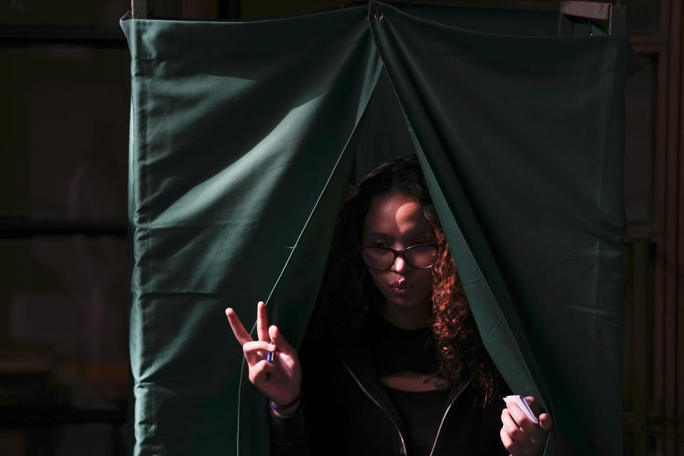 A voter holds her ballot after choosing her preferences on the draft of a new constitution in Santiago, Chile, Sunday, Dec. 17, 2023. For the second time in as many years, Chileans vote in a referendum on whether to replace the current constitution which dates back to the military dictatorship of Gen. Augusto Pinochet. (AP Photo/Esteban Felix)