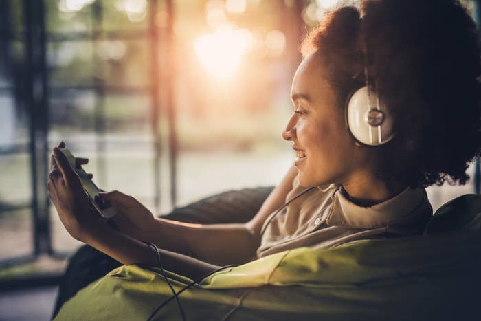 A woman with headphones listening to her playlist