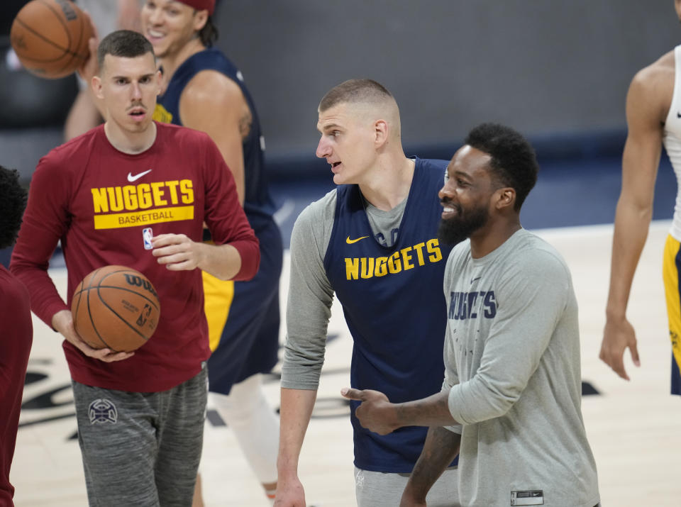 Denver Nuggets center Nikola Jokic, center, jokes around with forwards Vlatko Cancar, left, and Jeff Green during practice ahead of Game 1 of the NBA basketball finals against the Miami Heat Wednesday, May 31, 2023, in Denver. (AP Photo/David Zalubowski)