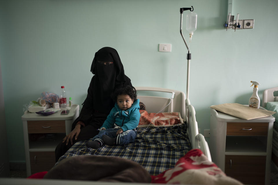 Yazan, 1, sits with his mother before his heart surgery at the Tajoura National Heart Center in Tripoli, Libya, on Feb. 27, 2020. Yazan’s odyssey from his small desert hometown barely skirted the war’s front lines. With key highways blocked because of fighting, his family took a 1,500-kilometer (932-mile) detour. (AP Photo/Felipe Dana)