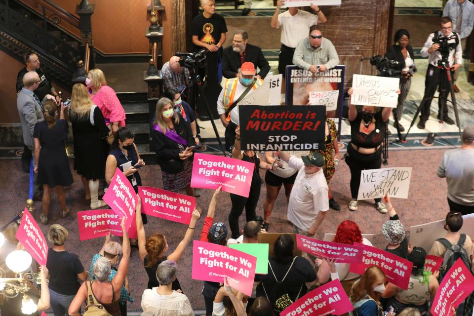 Protesters who support more abortion restrictions and protestors who are upset at the recent U.S. Supreme Court ruling removing protections for abortions demonstrate in the lobby of the South Carolina Statehouse on June 28, 2022, in Columbia, S.C. Some South Carolina lawmakers who oppose abortion are being cautious when it comes to tightening the state's already restrictive laws even further. The U.S. Supreme Court overturned Roe v. Wade in June, paving the way for states to enact total bans if they choose to do so. (AP Photo/Jeffrey Collins, File)