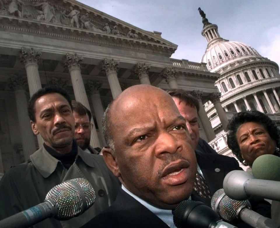 FILE - In this Friday, March 5, 1999, file photo, U.S. Rep. John Lewis, D-Ga., speaks with reporters in Washington. Lewis, who carried the struggle against racial discrimination from Southern battlegrounds of the 1960s to the halls of Congress, died Friday, July 17, 2020. (AP Photo/Khue Bui, File)