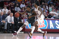 Washington State guard Noah Williams drives past Arizona State forward Jamiya Neal (55) during the first half of an NCAA college basketball game Wednesday, Dec. 1, 2021, in Tempe, Ariz. (AP Photo/Rick Scuteri)