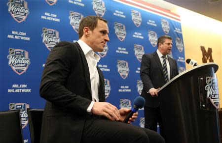 Dec 31, 2013; Ann Arbor, MI, USA; Toronto Maple Leafs defenseman Dion Phaneuf (left) listens to general manager Dave Nonis at a press conference during practice the day before the Winter Classic hockey game against the Detroit Red Wings at Michigan Stadium. Jerry Lai-USA TODAY Sports