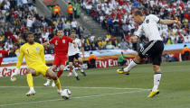 FILE - In this June 27, 2010 file photo Germany's Lukas Podolski, right, scores his side's second goal past England goalkeeper David James, left, during the World Cup round of 16 soccer match between Germany and England at Free State Stadium in Bloemfontein, South Africa. (AP Photo/Kirsty Wigglesworth, File)