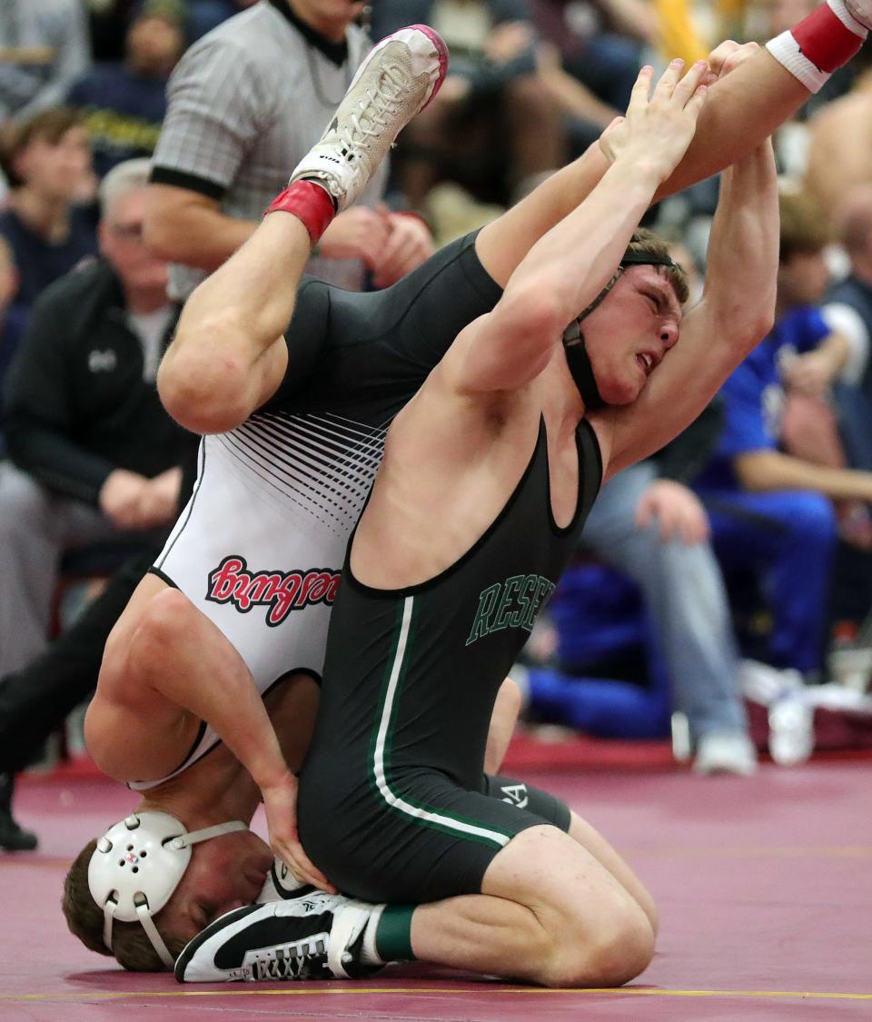 Sam Cartella of Western Reserve Academy, right, works under Mac Church of Waynesburg Central during their 144-pound championship match in the Ironman wrestling tournament at Walsh Jesuit High School, Saturday, Dec. 10, 2022.