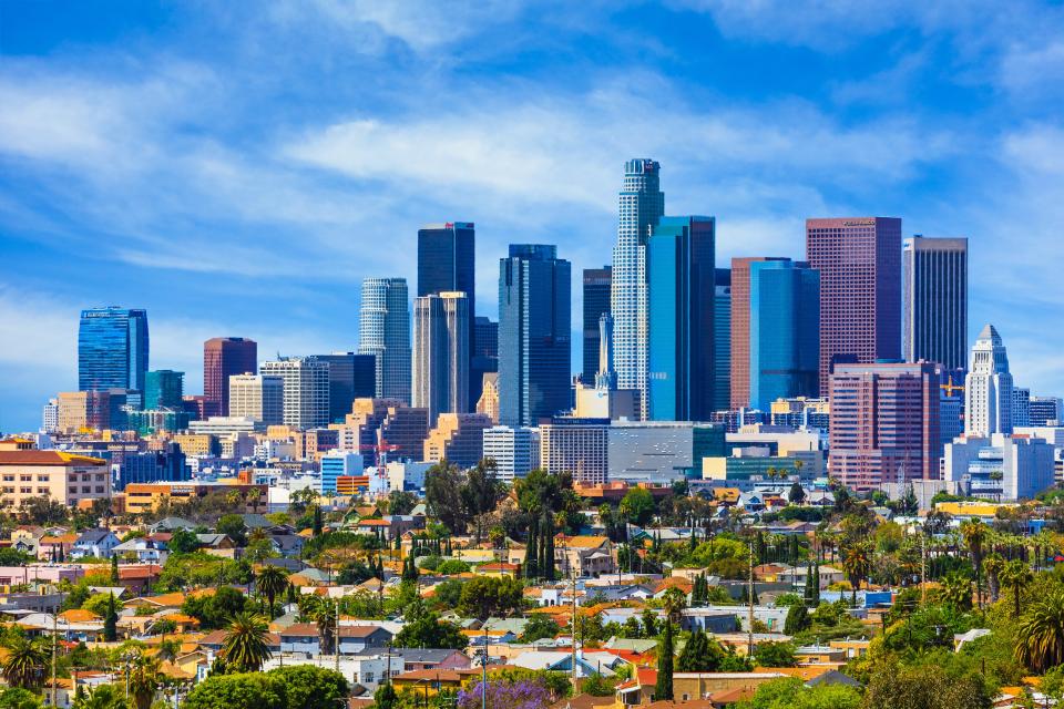 Urban sprawl fills the foreground leading back to the skyscrapers of Los Angeles skyline.