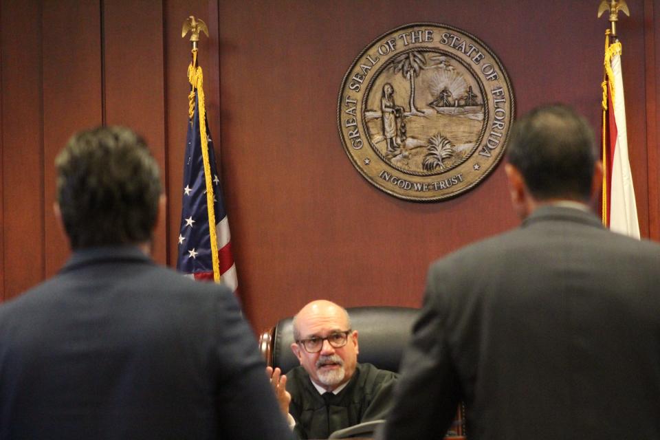 Circuit Judge James Clayton speaks to prosecutors Jason Lewis (right) and Andrew Urbanak on Friday, Dec. 9 during the trial of Marcus Pinckney at the Volusia County Courthouse in DeLand.