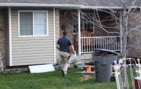 Pleasant Grove Police investigate the scene where seven infant bodies were discovered and packaged in separate containers at a home in Pleasant Grove, Utah, Sunday, April 13, 2014. (AP Photo/Rick Bowmer)