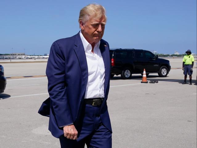 Trump pictured boarding his plane in Florida before flying to Waco (AP)