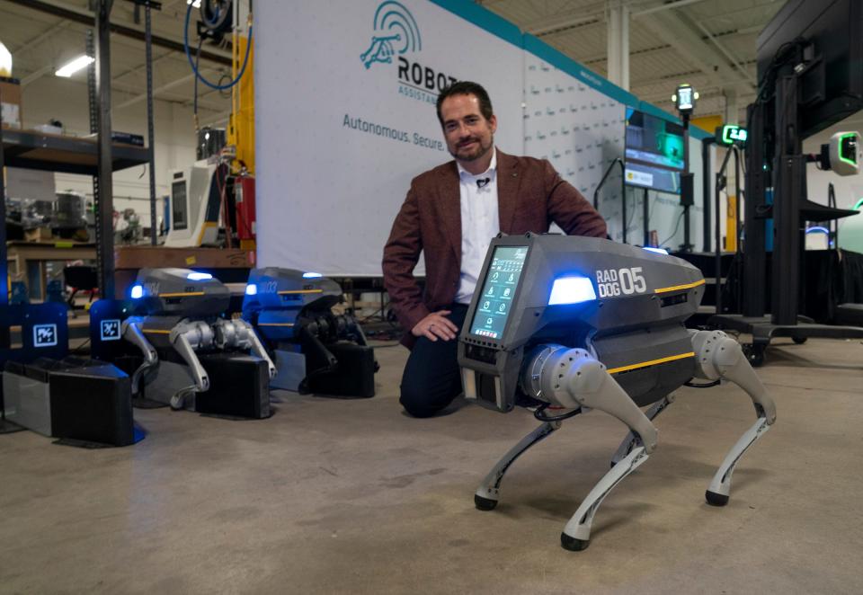 Steve Reinhorz, CEO of Artificial Intelligence Technology Solutions, Inc. (AITX) in Ferndale, poses Wednesday, Dec. 7, 2022, with his company's latest technology robot dog called RADDOG. The robot is developed specifically for the security and property management industries. This innovative artificial intelligence-based canine device can be autonomously dispatched, creating an independent stationary and mobile security and intrusion preemption footprint. This robot can follow you like a curious dog.