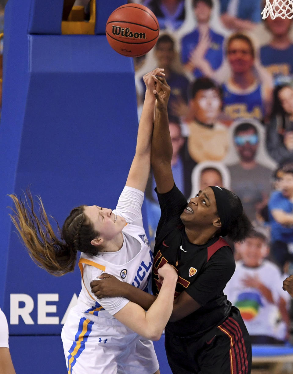 UCLA's Lindsey Corsaro, left, fights for the rebound against Southern California's Jordyn Jenkins, right, in the second half of an NCAA college basketball game at Pauley Pavilion in Westwood, Calif., Friday, Feb. 26, 2021. (Keith Birmingham/The Orange County Register via AP)