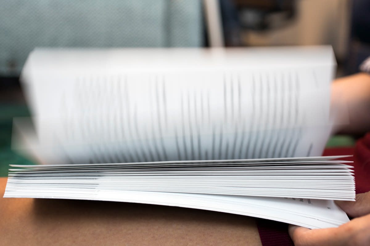 A person looks at a book. 