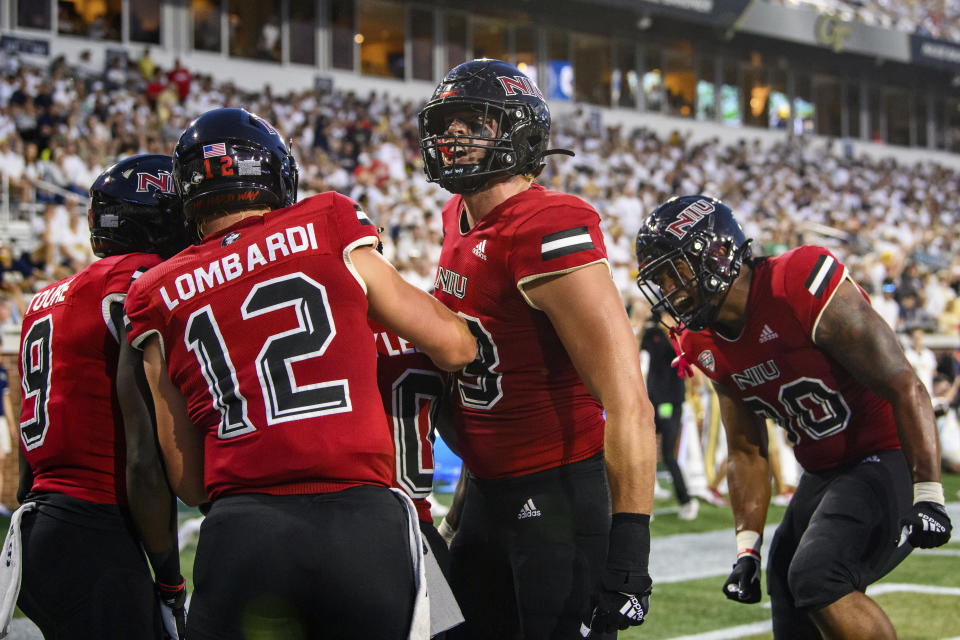 Northern Illinois quarterback Rocky Lombardi (12), wide receiver Mohamed Toure (9), tight end Liam Soraghan (83) and tight end Miles Joiner (80) celebrate a touchdown by running back Harrison Waylee (30) during the first half of an NCAA college football game against Georgia Tech on Saturday, Sept. 4, 2021, in Atlanta. (AP Photo/Danny Karnik)