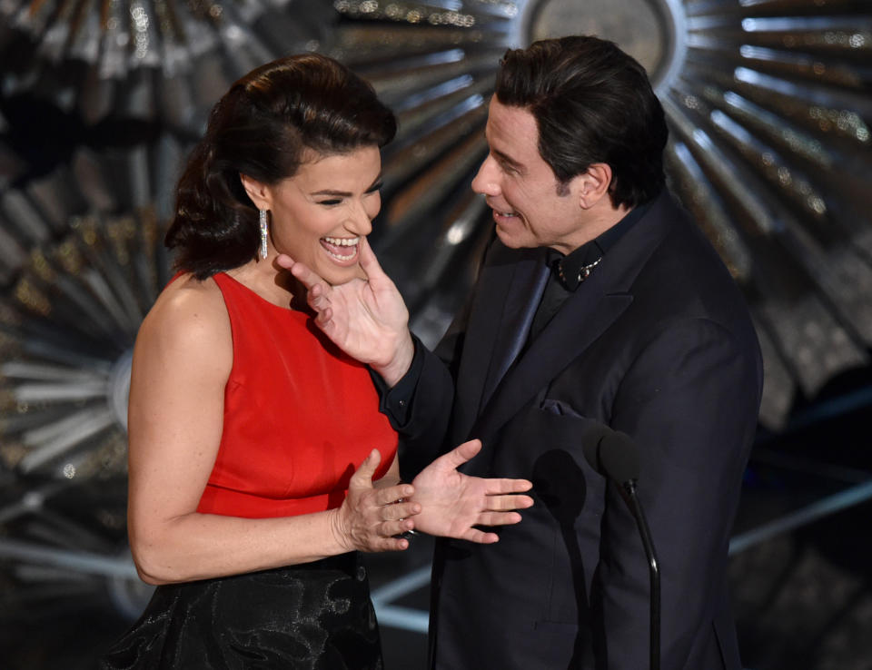 Idina Menzel, left, and John Travolta present the award for best original song at the Oscars on Sunday, Feb. 22, 2015, at the Dolby Theatre in Los Angeles. (Photo by John Shearer/Invision/AP)