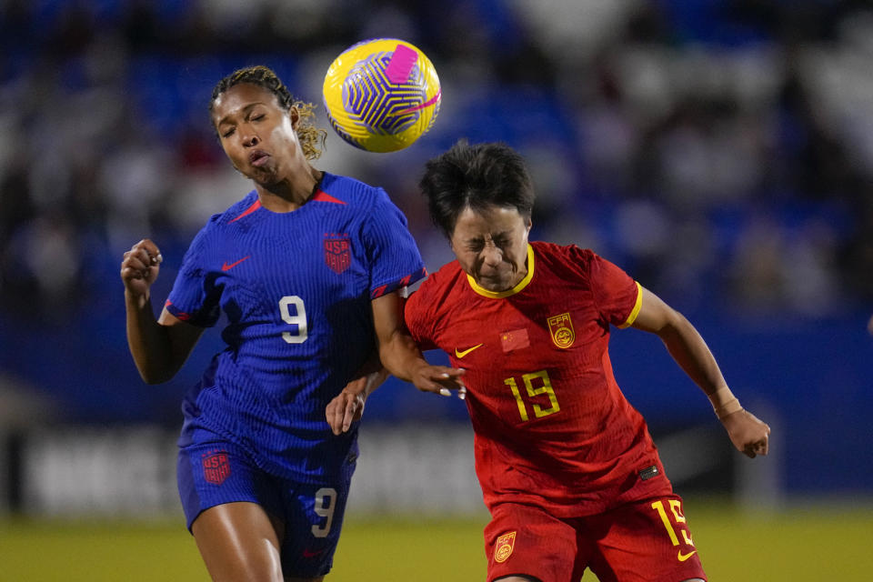 United States' Midge Purce, left, and China's Zhang Linyan compete for the ball during the second half of a women's international friendly soccer match, Tuesday, Dec. 5, 2023, in Frisco, Texas. (AP Photo/Julio Cortez)