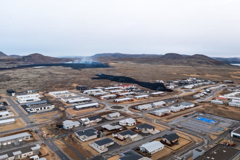A drone is capturing the town of Grindavik during the eruption in Grindavik, Iceland, on January 15, 2024. On Sunday morning, a new eruption is occurring north of Grindavik in southwestern Iceland, prompting residents to evacuate due to increased seismic activity around 03:00 GMT. The alert level is currently at ”emergency,” indicating a potential threat to people, communities, property, or the environment.