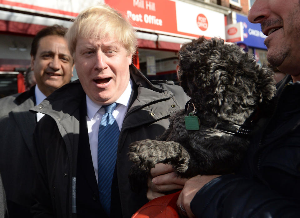 Mayor of London Boris Johnson after being licked by a dog as he meets members of the public and local business owners after launching the Conservative London campaign at Hartley Hall in Mill Hill, London.