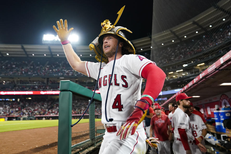 Los Angeles Angels' Brett Phillips (4) celebrates in the dugout after hitting a home run during the ninth inning of a baseball game against the Detroit Tigers in Anaheim, Calif., Saturday, Sept. 16, 2023. (AP Photo/Ashley Landis)