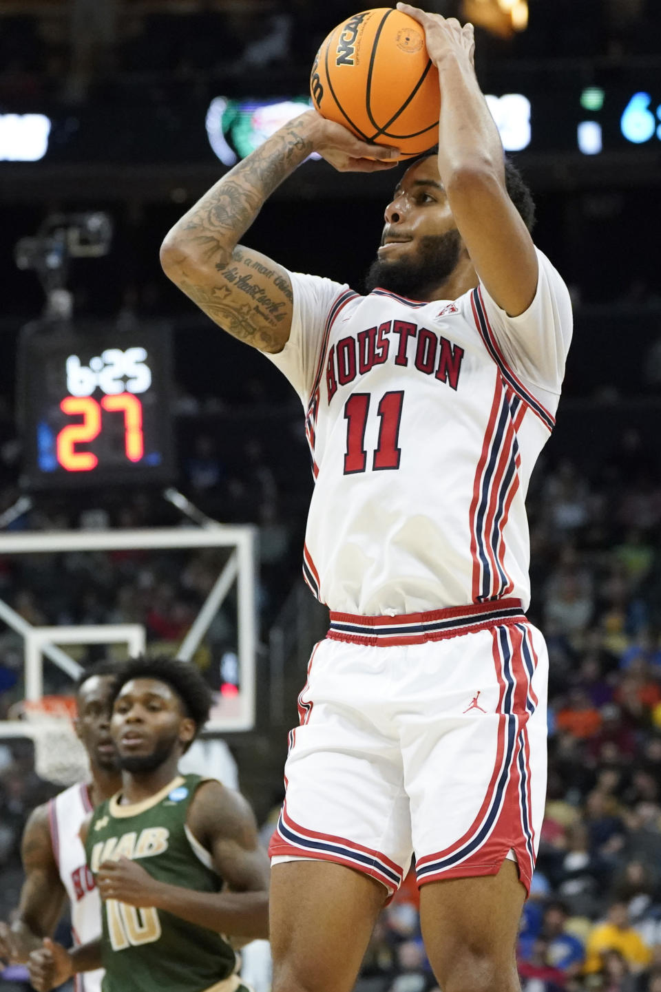 Houston's Kyler Edwards (11) prepares to shoot a 3-point basket in front of UAB's Jordan Walker (10) during the first half of a college basketball game in the first round of the NCAA tournament, Friday, March 18, 2022, in Pittsburgh. (AP Photo/Keith Srakocic)