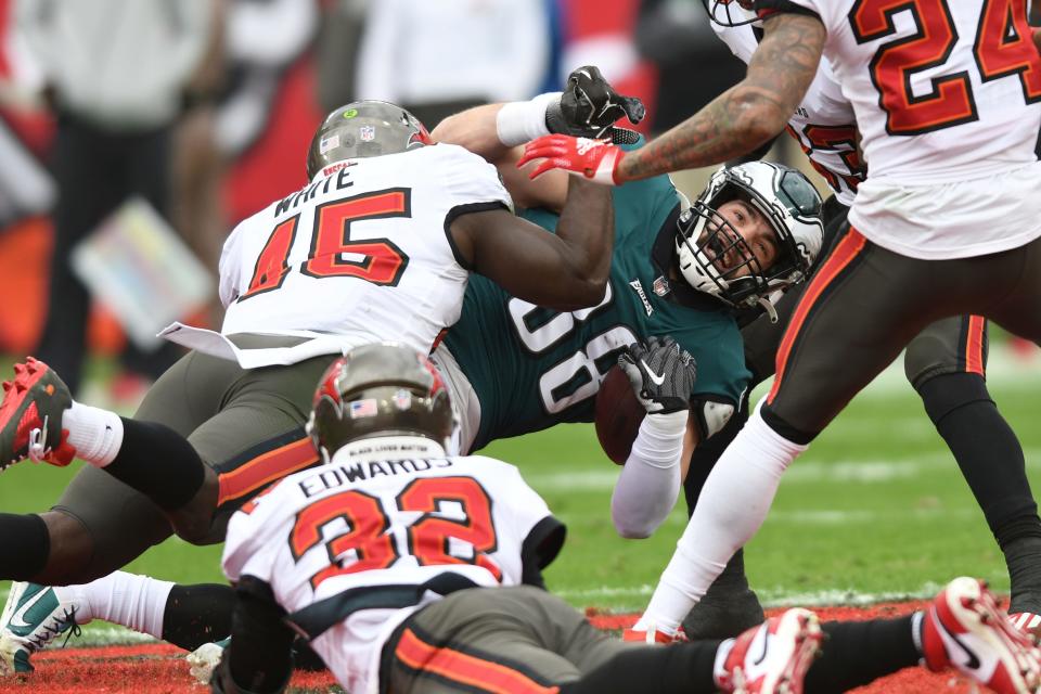 Philadelphia Eagles tight end Dallas Goedert (88) is taken down by Tampa Bay Buccaneers inside linebacker Devin White (45) during the first half.