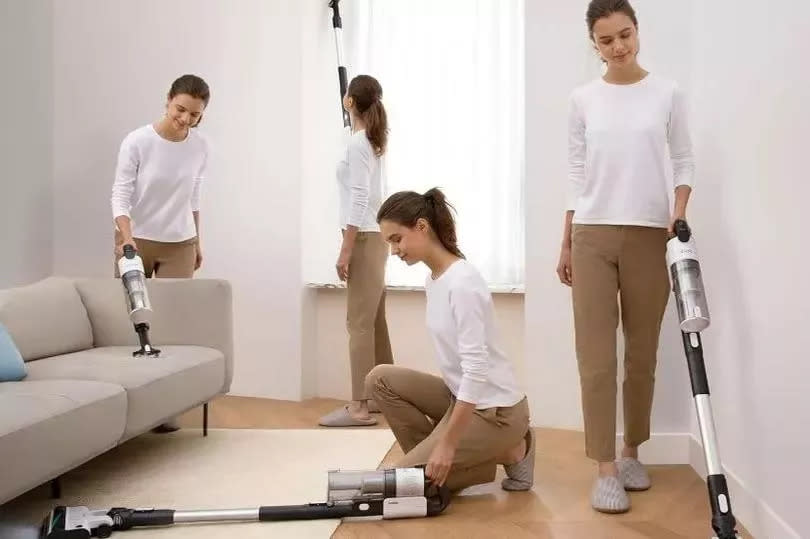 Woman using the LEVOIT cordless vacuum cleaner around the living room