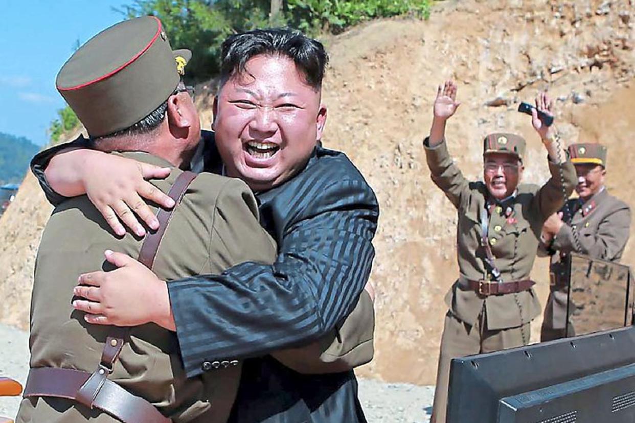 Ramping up the tension: North Korean leader Kim Jong-un celebrates after a missile launch earlier this month: Getty Images