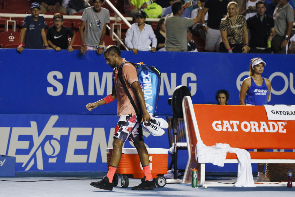 Australia's Nick Kyrgios walks off the court to boos from the crowd, after retiring from a match against France's Ugo Humbert during the first round of the Mexican Open tennis tournament in Acapulco, Mexico, Tuesday, Feb. 25, 2020. (AP Photo/Rebecca Blackwell)