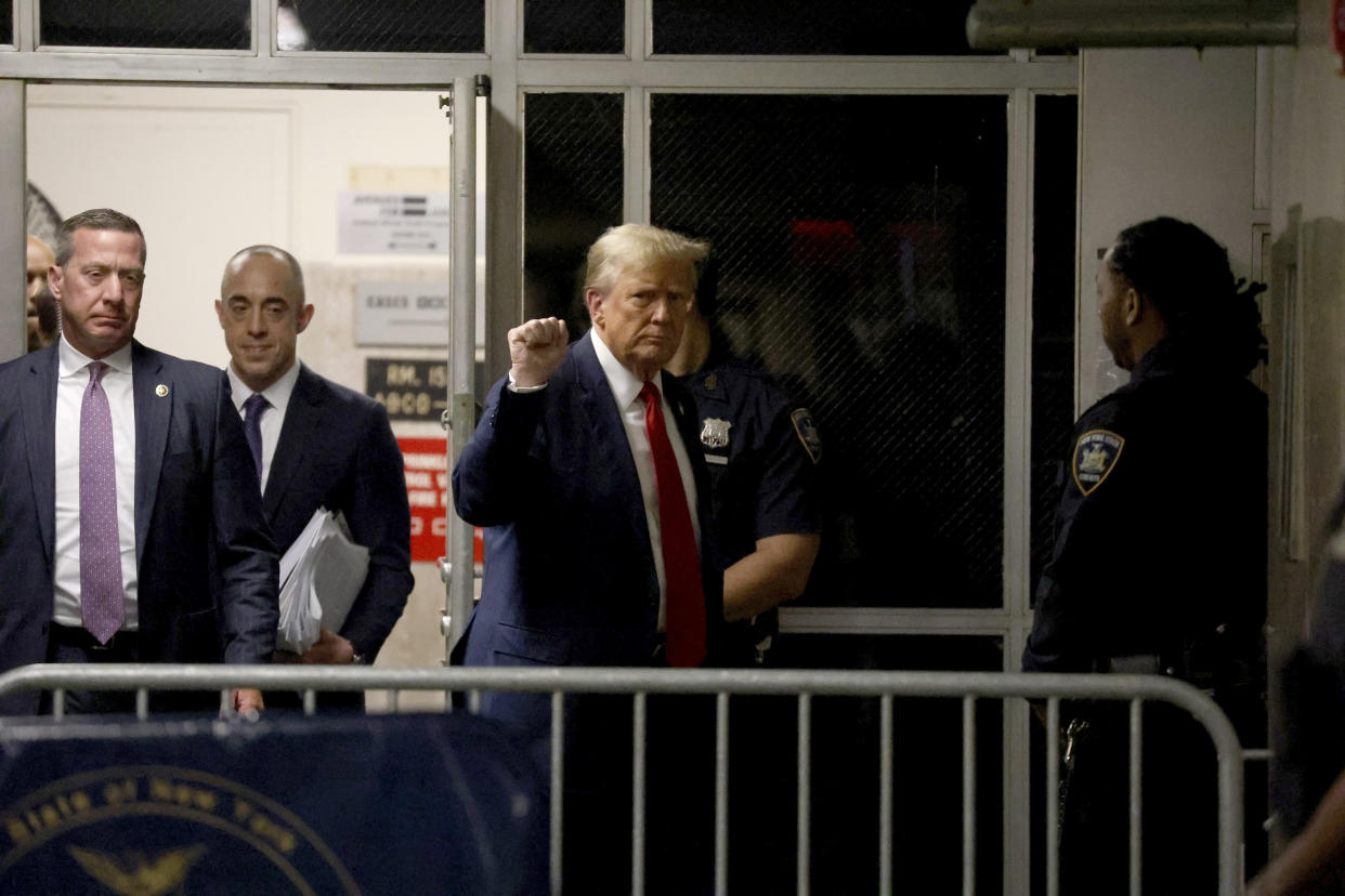 Former President Donald Trump raises a fist outside the courtroom as he returns from lunch in his criminal trial at Manhattan Criminal Court in Manhattan, on Thursday, April 25, 2024.. (Jefferson Siegel/The New York Times)