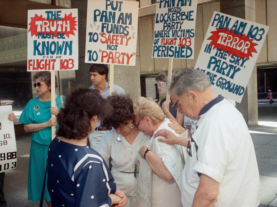 Florence Bissett is consoled by relatives of other Pan Am flight 103 crash victims during a protest outside of Pan Am headquarters in New York