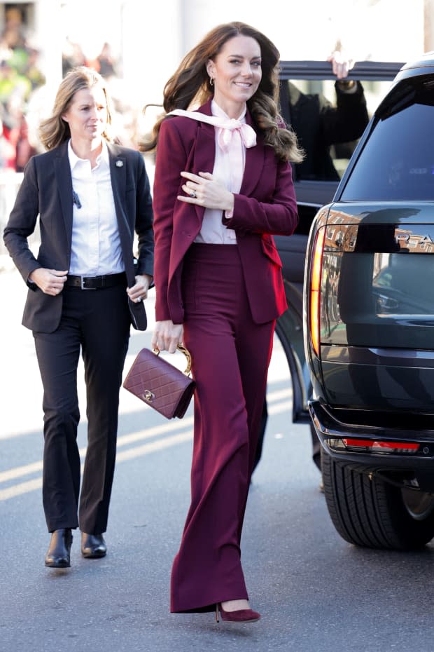 <p>Kate Middleton rocks a burgundy suit with a pale pink bow blouse in Boston in December 2022.</p><p>Chris Jackson/Getty Images</p>