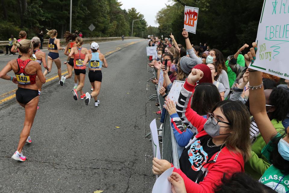 Racers went through the traditional Scream Tunnel made up of Wellesley College students during the running of the 125th Boston Marathon, Oct. 11, 2021.