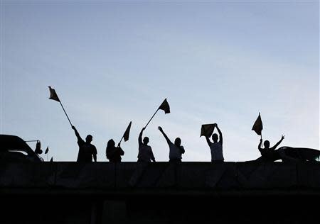 Supporters wave party flags of Luis Guillermo Solis, presidential candidate of the Citizens' Action Party (PAC), as they march through the streets, during the presidential election run-off in San Jose April 6, 2014. REUTERS/Juan Carlos Ulate