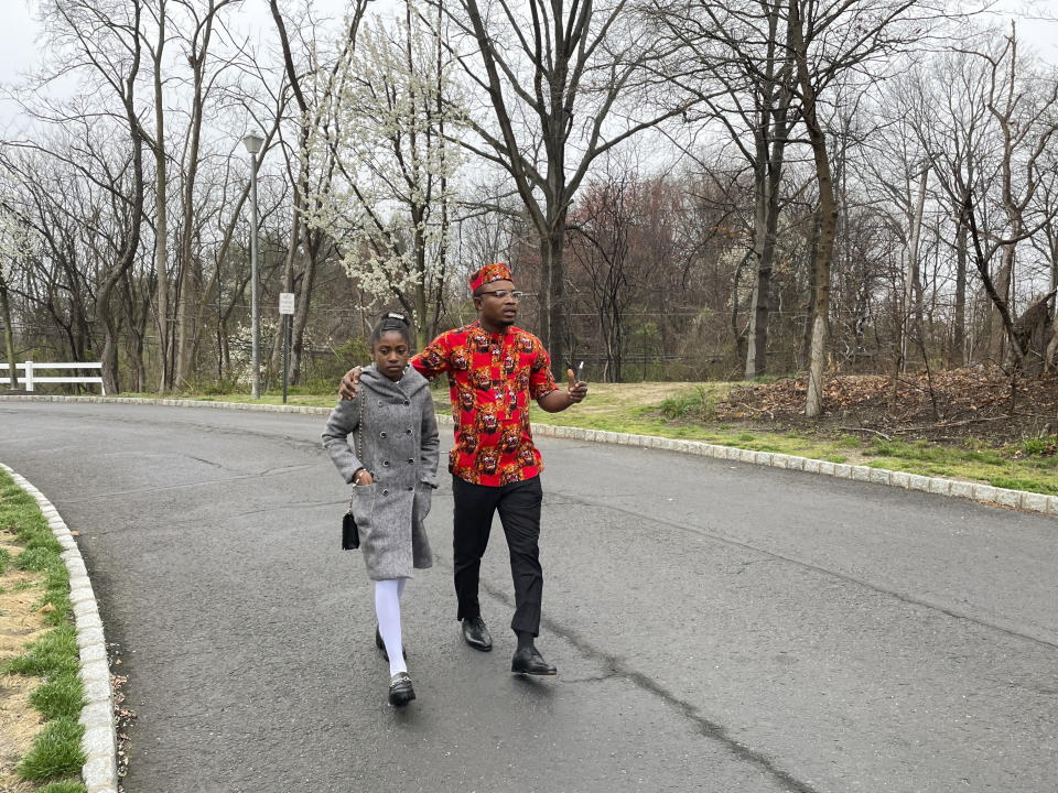 Nicole Teliano and Peter Ezechukwu visit the scene of the fatal shooting of their family member, Eunice Dwumfour, in Sayreville, N.J., April 5, 2023. Eunice Dwumfour, a Sayreville council member, was gunned down Feb. 1 as she arrived home in Sayreville. (AP Photo/Maryclaire Dale)