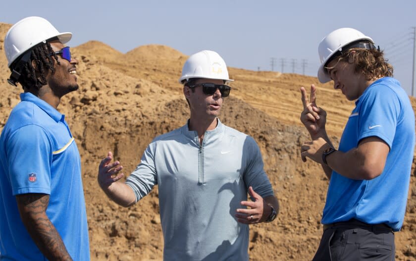 El Segundo, CA - May 18: Los Angeles Chargers from right to left, quarterback Justin Herbert, coach Brandon Staley and safety Derwin James chat during Chargers groundbreaking ceremony for the team's future headquarters and training facility Wednesday, May 18, 2022 in El Segundo, CA. (Brian van der Brug / Los Angeles Times)