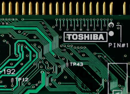 FILE PHOTO: A logo of Toshiba Corp is seen on a printed circuit board in this photo illustration taken in Tokyo July 31, 2012.   REUTERS/Yuriko Nakao/File Photo