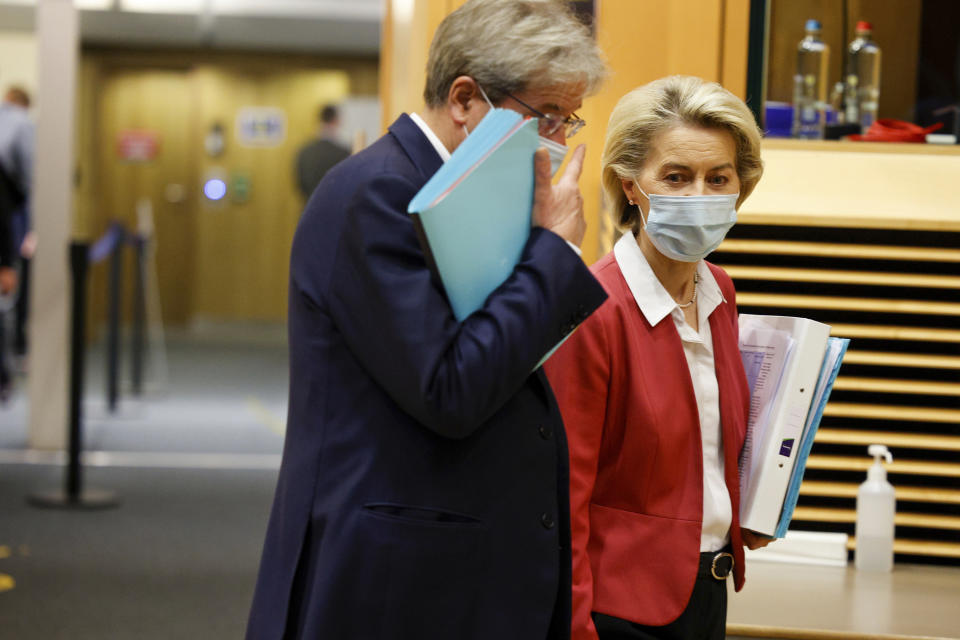 European Commissioner for Economics Paolo Gentiloni talks with President of the European Commission Ursula von der Leyen at the College of Commissioners in Brussels, Wednesday, Dec 1, 2021. (AP Photo/Olivier Matthys, Pool)