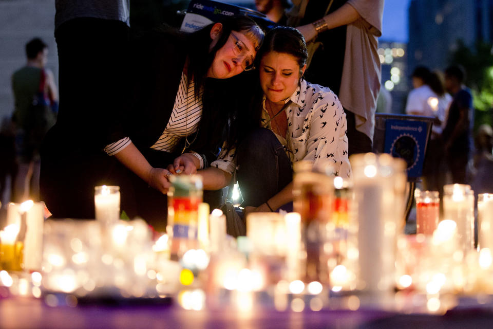 <p>People gather for a vigil in memory of the victims of the Orlando mass shooting, on Monday, June 13, 2016, at City Hall in Philadelphia. A gunman opened fire inside a crowded gay nightclub early Sunday, before dying in a gunfight with SWAT officers, police said. (Photo: Matt Rourke/AP) </p>