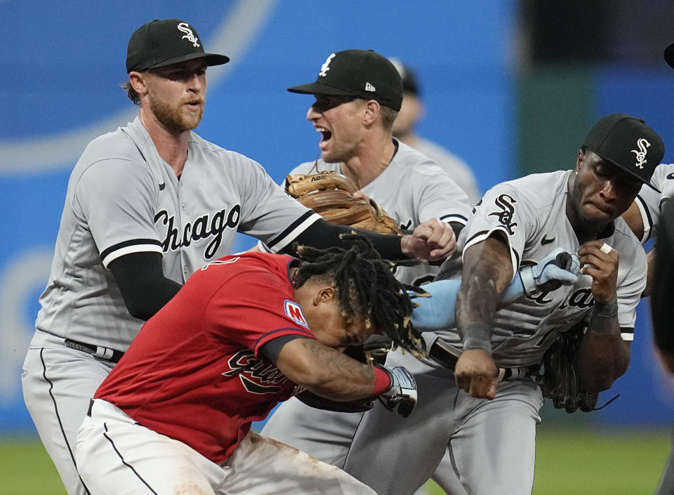 Chicago White Sox's Tim Anderson, right, punches Cleveland Guardians' Jose Ramírez, center, in the sixth inning of a baseball game Saturday, Aug. 5, 2023, in Cleveland. White Sox pitcher Michael Kopech, left, looks on. (AP Photo/Sue Ogrocki)