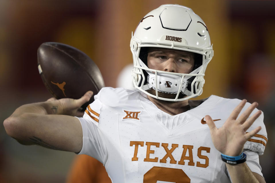 Texas quarterback Quinn Ewers warms up before an NCAA college football game against Iowa State, Saturday, Nov. 18, 2023, in Ames, Iowa. (AP Photo/Matthew Putney)