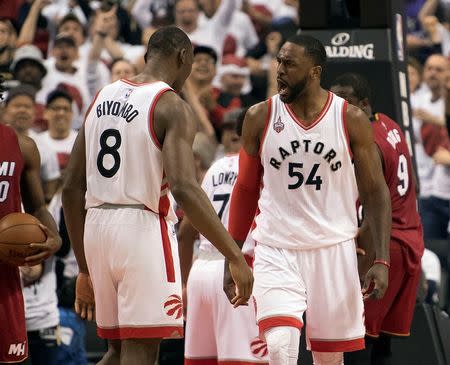 May 15, 2016; Toronto, Ontario, CAN; Toronto Raptors forward Patrick Patterson (54) celebrates with Toronto Raptors center Bismack Biyombo (8) after scoring a basket during the second quarter in game seven of the second round of the NBA Playoffs against the Miami Heat at Air Canada Centre. Mandatory Credit: Nick Turchiaro-USA TODAY Sports