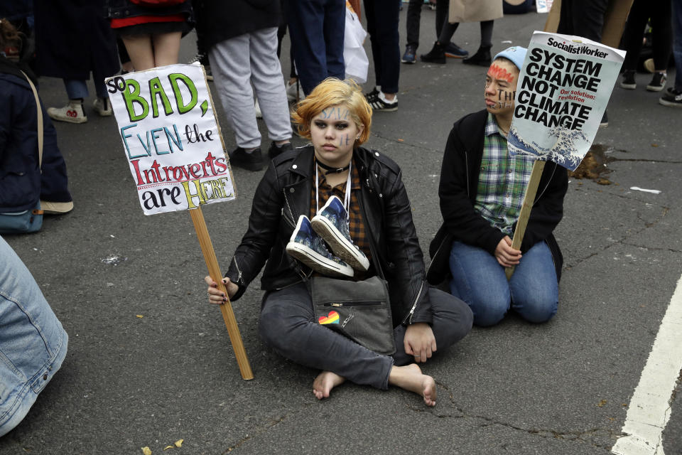 Youngsters sit in the road by Trafalgar Square as they take part in a student climate protest at the bottom of Westminster Bridge in London, Friday, March 15, 2019. Students in more than 80 countries and territories worldwide plan to skip class Friday in protest over their governments' failure to act against global warming. The coordinated 'school strike' was inspired by 16-year-old activist Greta Thunberg, who began holding solitary demonstrations outside the Swedish parliament last year. (AP Photo/Matt Dunham)