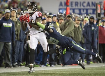 Nov 20, 2017; Seattle, WA, USA; Atlanta Falcons wide receiver Julio Jones (11) catches a pass for a first down as he is tackled by Seattle Seahawks cornerback Jeremy Lane (20) during the second half at CenturyLink Field. The Falcons won 34-31. Troy Wayrynen-USA TODAY Sports