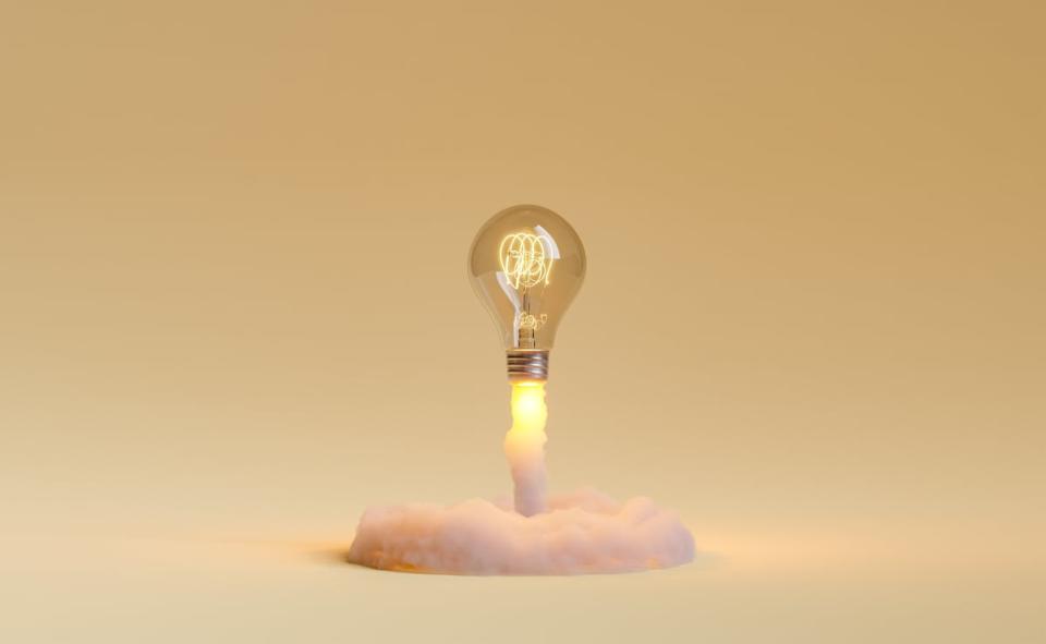 Light bulb shooting out like a rocket on a golden background.