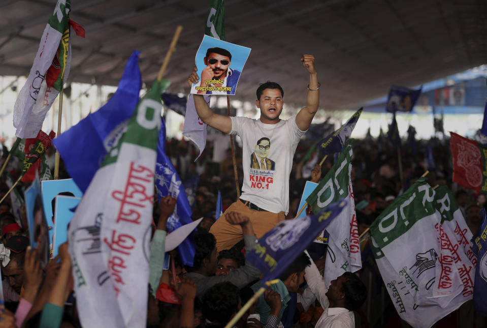 A participant displays a picture of Dalit leader Chandrasekhar Azad as supporters of Bahujan Samaj Party (BSP), Samajwadi Party (SP) and Rashtriya Lok Dal (RLD) gather during an election rally in Deoband, Uttar Pradesh, India, Sunday, April 7, 2019. Political archrivals in India's most populous state rallied together Sunday, asking voters to support a new alliance created with the express purpose of defeating Prime Minister Narendra Modi's ruling Hindu nationalist Bharatiya Janata Party. (AP Photo/Altaf Qadri)