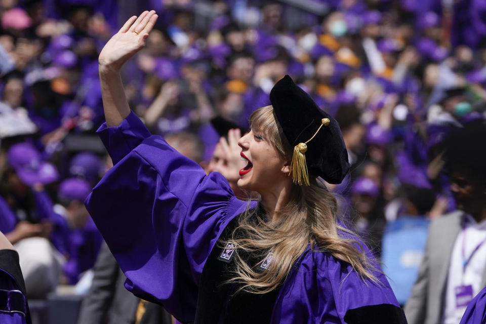 Taylor Swift, center, waves to graduates as she participates in a graduation ceremony for New York University at Yankee Stadium in New York, Wednesday, May 18, 2022. (AP Photo/Seth Wenig)