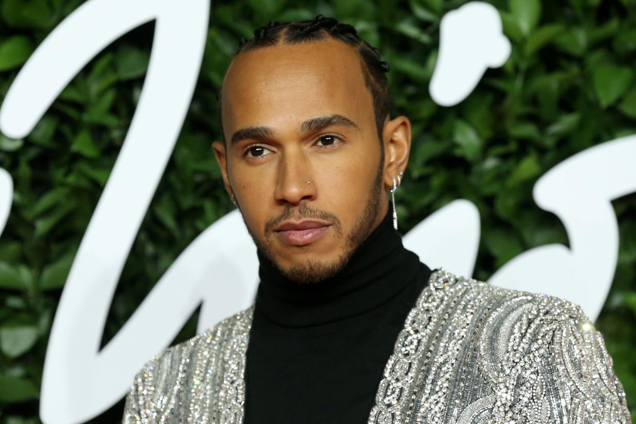 British Formula One (F1) driver Lewis Hamilton poses on the red carpet upon arrival at The Fashion Awards 2019 in London on December 2, 2019. - The Fashion Awards are an annual celebration of creativity and innovation will shine a spotlight on exceptional individuals and influential businesses that have made significant contributions to the global fashion industry over the past twelve months. (Photo by Isabel Infantes / AFP) / RESTRICTED TO EDITORIAL USE -  NO MARKETING NO ADVERTISING CAMPAIGNS (Photo by ISABEL INFANTES/AFP via Getty Images)