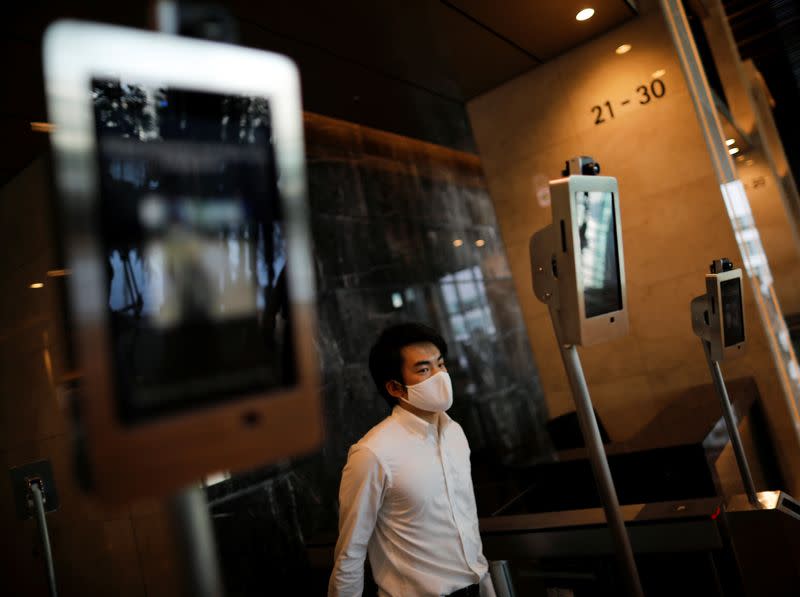 Facial recognition and elevator navigation systems are seen at the entrance hall of SoftBank's new headquarters building in Tokyo